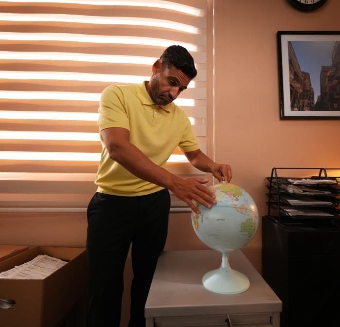 Islam Fawzy spinning a globe